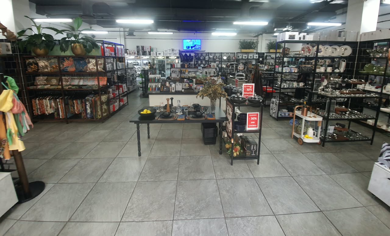 Inside Cookin Ballito today: aisles of cookware, knives, tableware and textiles