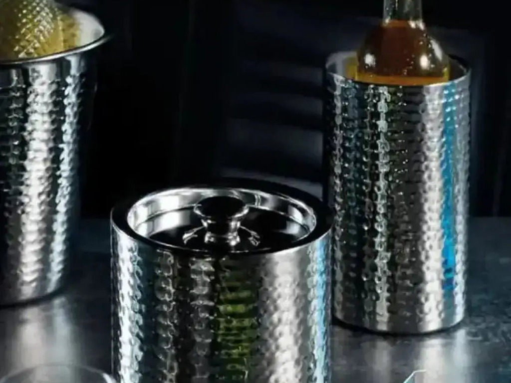 BarCraft hammered stainless steel wine coolers on a dark bar with a chilled wine bottle