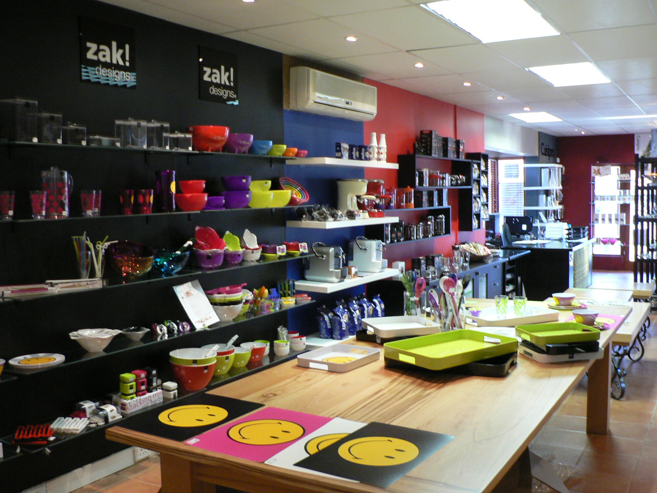 The original Cookin store in the KZN Midlands in 2010, with colourful Zak! Designs tableware on dark shelving
