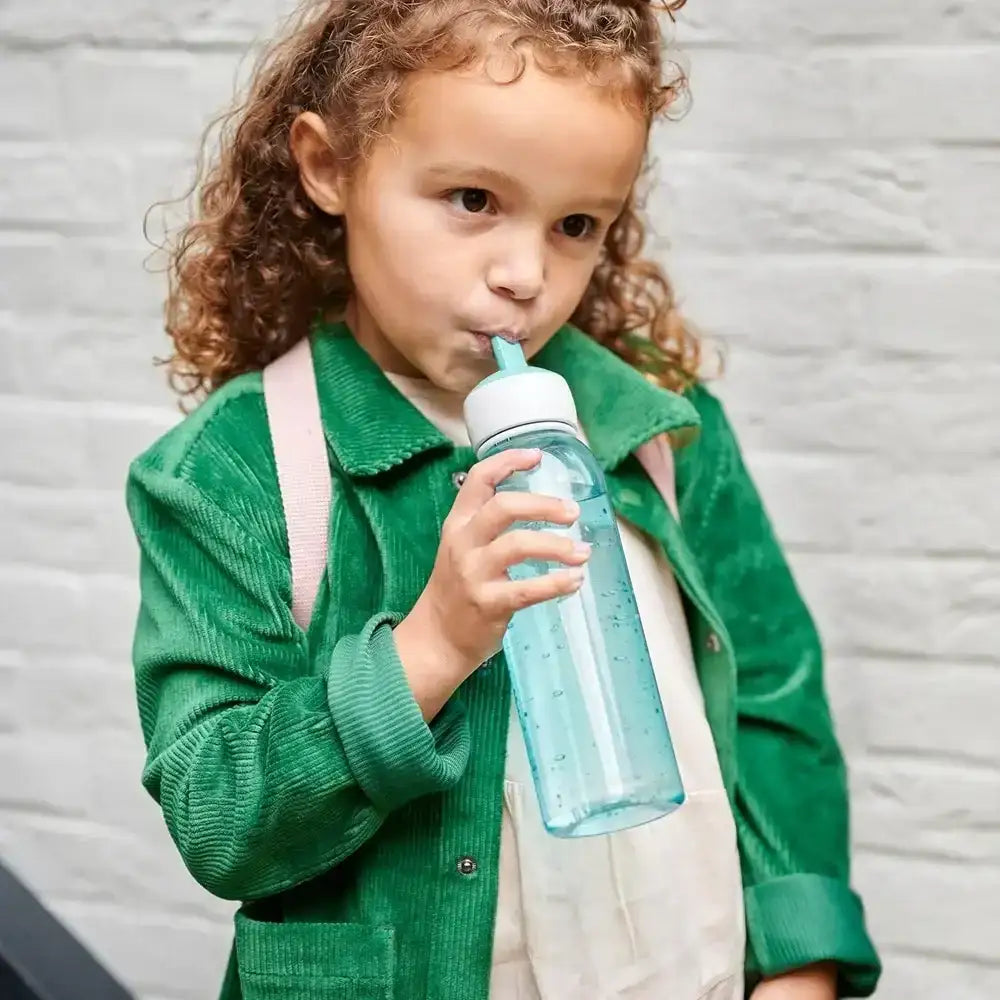 A child drinking from a Mepal Campus cool mint water bottle with a flip straw