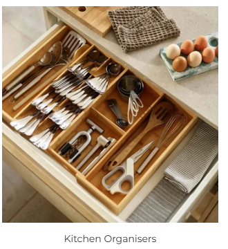 Open kitchen drawer fitted with bamboo organiser trays holding neatly sorted cutlery and kitchen utensils