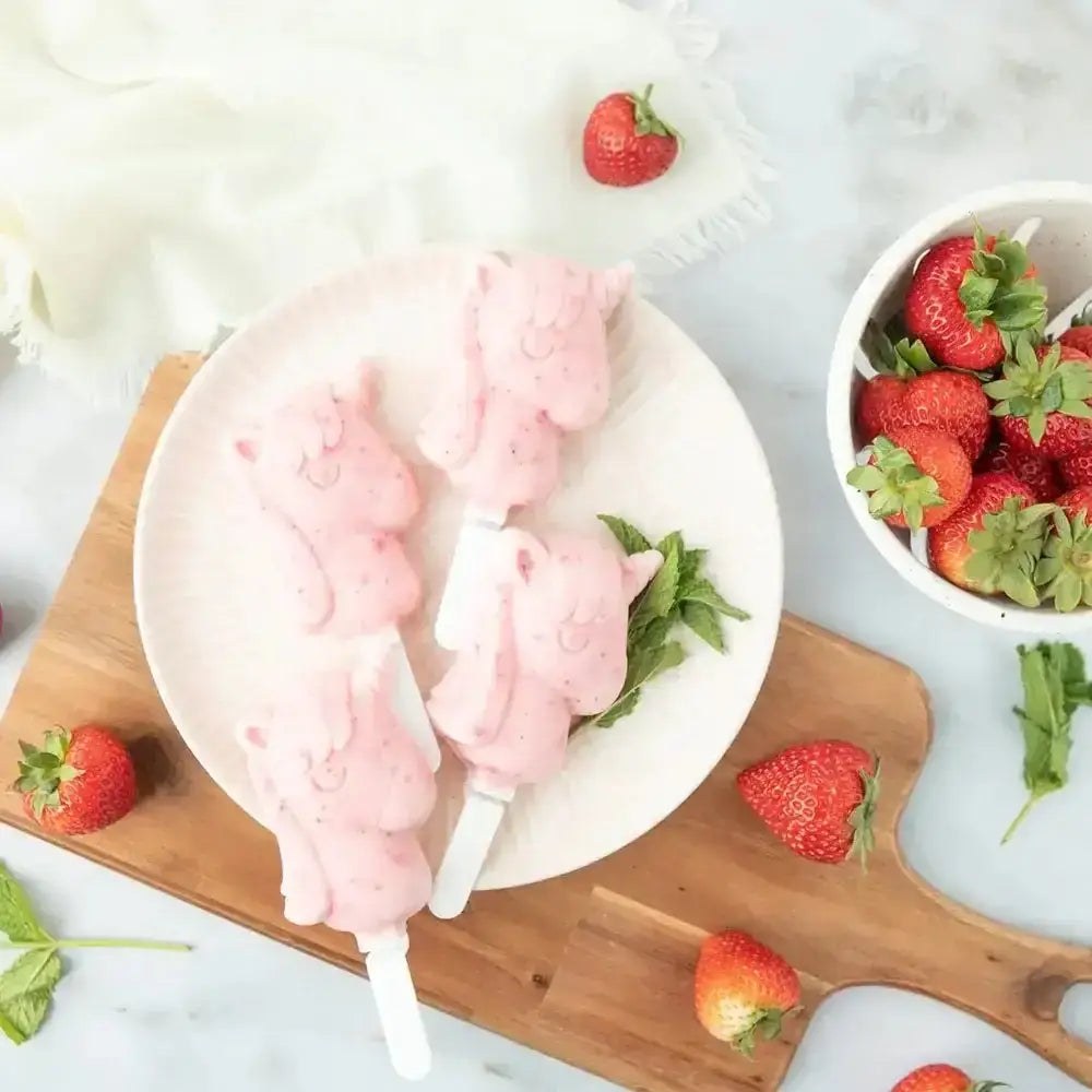 Zoku unicorn ice pop freezer moulds filled with brightly coloured home-made ice lollies