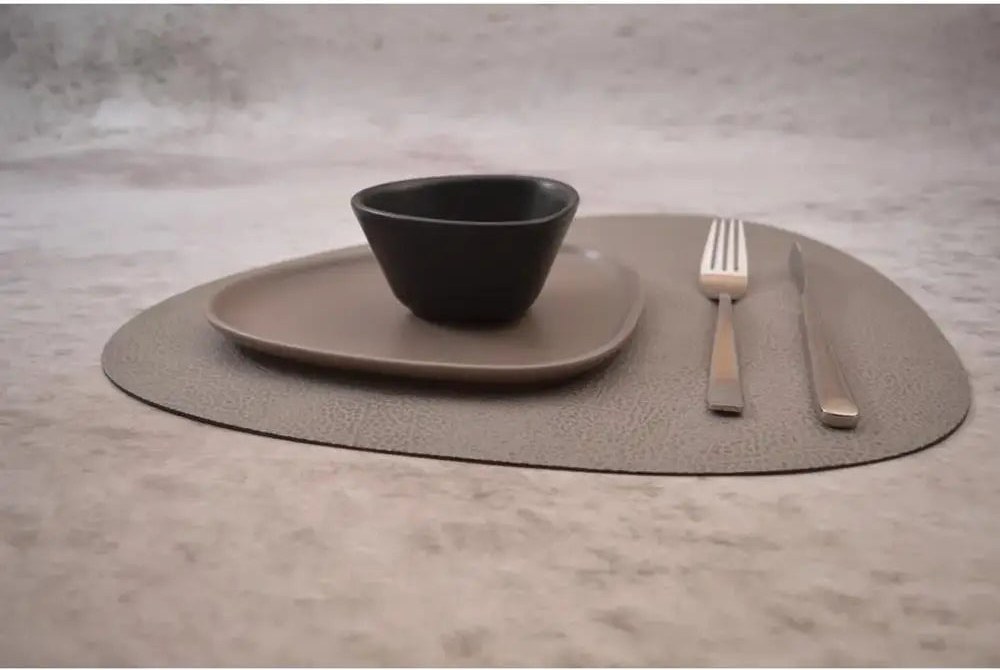 Lind DNA curved leather placemat at a modern place setting